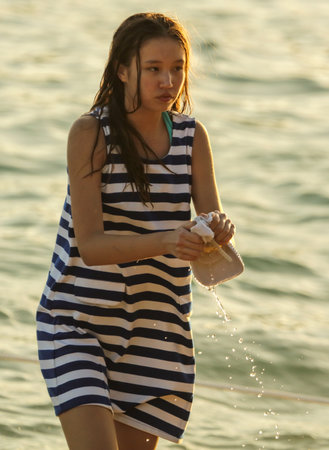 Sanya, Hainan Island, China - January 8, 2020: Girl on the beach in Dadonghai Bay.のeditorial素材