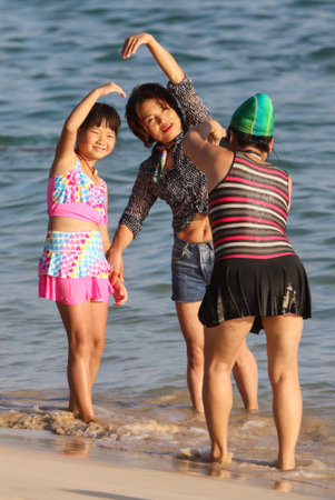 Sanya, Hainan Island, China - January 8, 2020: People bathe on the beach in Dadonghai Bay.のeditorial素材