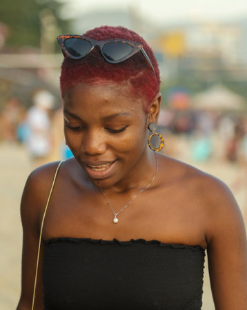 Sanya, Hainan Island, China - January 8, 2020: Black woman girl on the beach in Dadonghai Bay.のeditorial素材