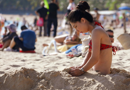 Sanya, Hainan Island, China - January 8, 2020: Girl on the beach in Dadonghai Bay.のeditorial素材