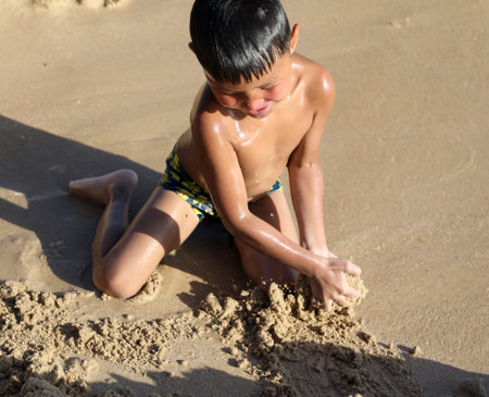 Sanya, Hainan Island, China - January 8, 2020: Boy on the beach in Dadonghai Bay.のeditorial素材