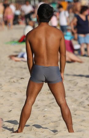 The back of a man in the sand on the beach.の写真素材