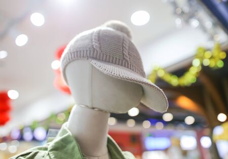 Clothes on a mannequin in a shop window.