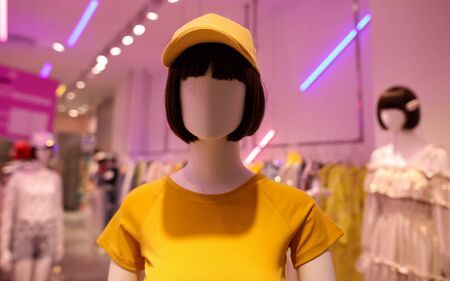 Clothes on a mannequin in a shop window.の写真素材