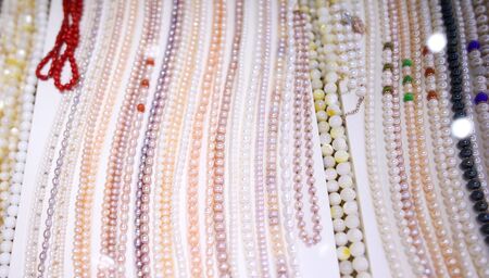 Necklace of stones and pearls in a shop window.の写真素材