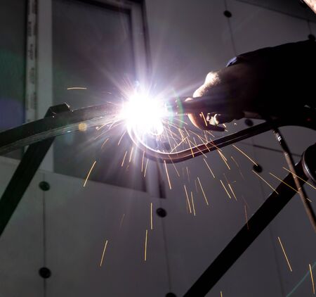sparks from metal welding at a construction site.