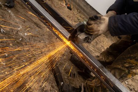 Sparks from sawing metal at a construction site.の写真素材