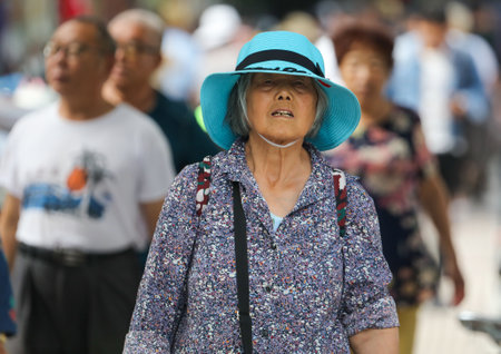 Sanya, Hainan Island, China - January 14, 2020: Chinese grandmother on a city street.のeditorial素材