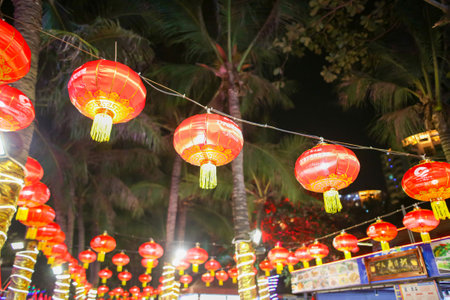 Sanya, Hainan Island, China - January 14, 2020: Chinese lanterns glow on the city street at night.