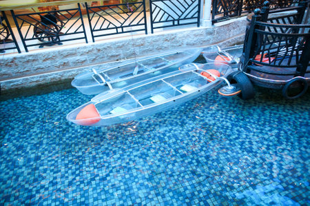 Sanya, Hainan Island, China - January 14, 2020: A boat floats on a river in an underground shopping center.のeditorial素材