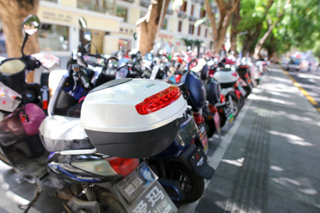 Sanya, Hainan Island, China - January 14, 2020: Motorcycles and scooters on the city streets.