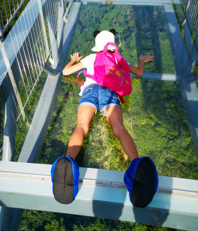 Sanya, Hainan Island, China - January 14, 2020: Girl on a glass bridge in Yanoda Park.のeditorial素材