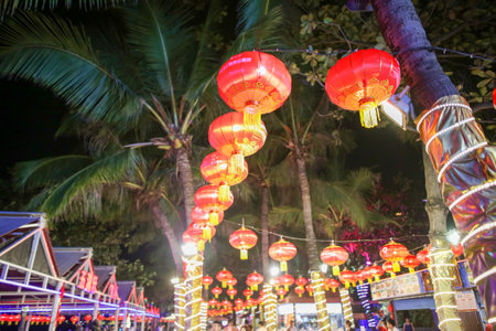 Sanya, Hainan Island, China - January 14, 2020: Chinese lanterns glow on the city street at night.のeditorial素材