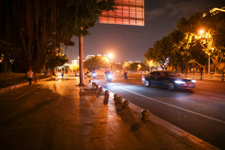 Sanya, Hainan Island, China - January 10, 2020: Shops and roads in the city streets at night.のeditorial素材