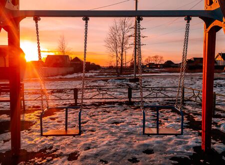 Swing in the winter at sunset.