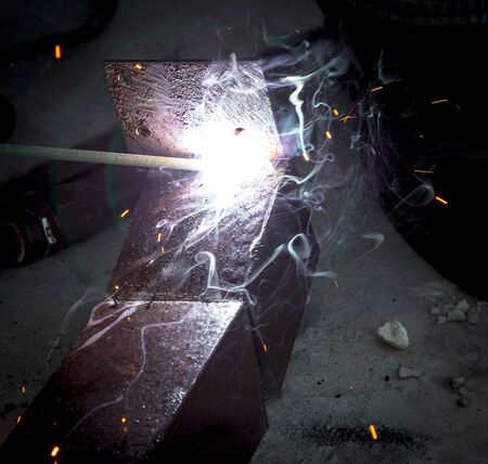 Sparks from welding at a construction site.