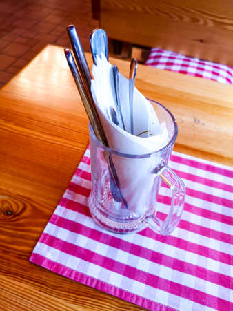 Cutlery in a mug on a table in a restaurant.の写真素材
