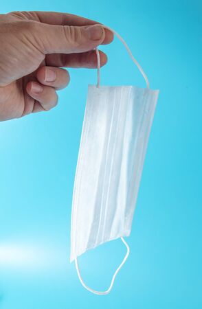 The mask in the hands of a male doctor.の写真素材