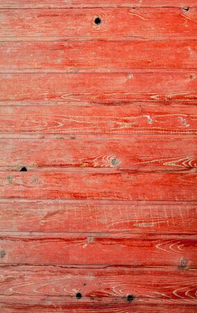 Old wooden boards on a fence painted with red paint. Abstract backgroundの写真素材