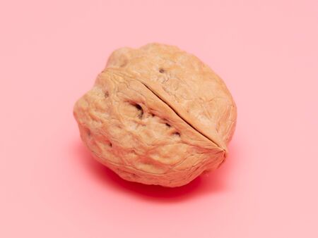 Walnut on a pink background. Food