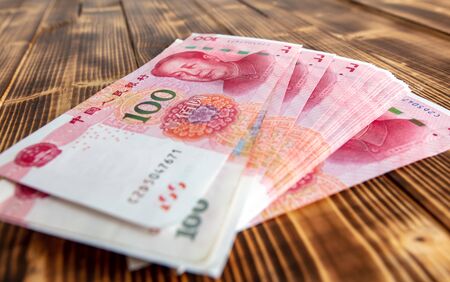One hundred Chinese yuan on a wooden background.の写真素材