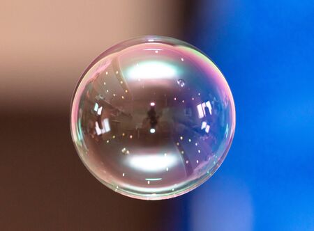 A beautiful soap bubble flies in the house. Ball