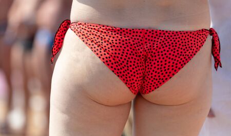 Beautiful body of a girl in a swimsuit on the beach.の写真素材