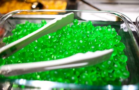 Green marmalade on the counter in the market as a background.