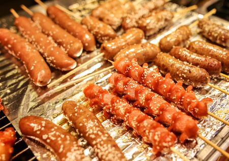 Sausages on wooden sticks for grilling. A dish of Chinese cuisine.