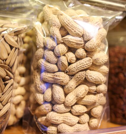 Various nuts in bags on the counter in the market.