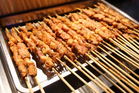 Animal meat on wooden sticks for grilling. A dish of Chinese cuisine.の写真素材