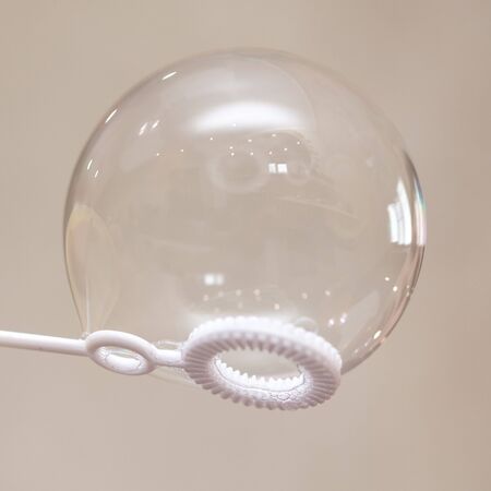 Soap bubble in the boy's hand.