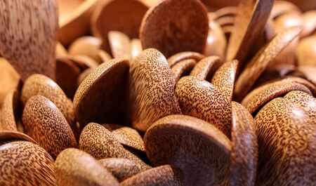 Coconut tree spoons on a counter in a shopping center as a background.