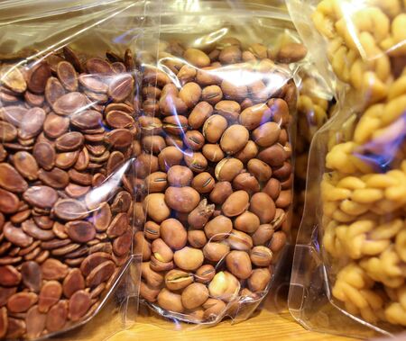 Various nuts in bags on the counter in the market.