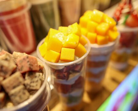Sweet ice cream with fruits and berries on the counter.の写真素材