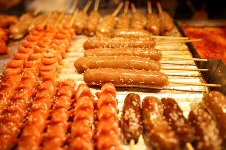 Sausages on wooden sticks for grilling. A dish of Chinese cuisine.
