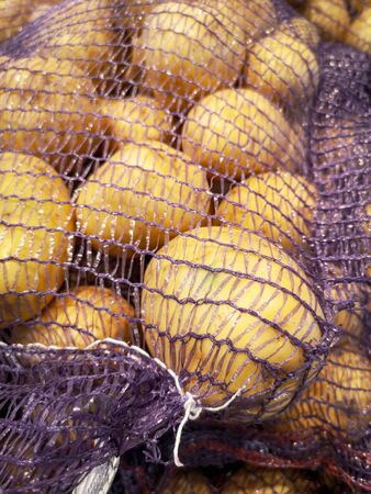 Potatoes on a shelf in a store. Fresh root vegetablesの写真素材