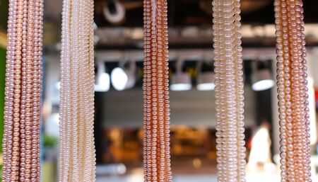 Pearl beads on a counter in a shopping center.