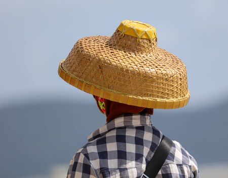 Girl in a straw hat on the beach by the sea.の写真素材