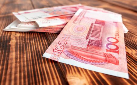 One hundred Chinese yuan on a wooden background.の写真素材