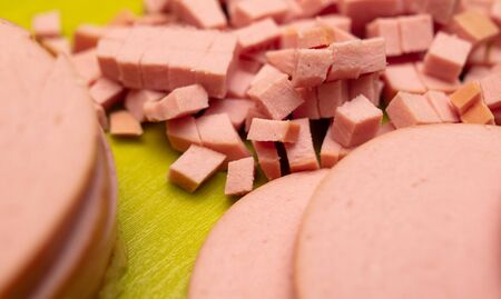 Sliced sausage on a plastic board. Cooking food