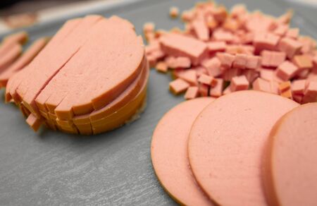 Sliced sausage on a plastic board. Cooking foodの写真素材