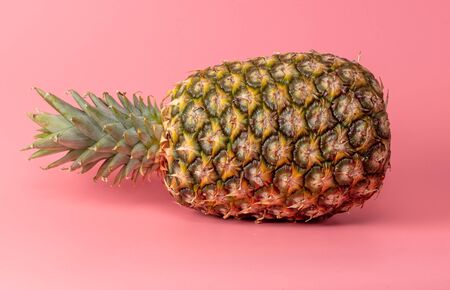 Pineapple isolated on a pink background. Tropical fruit.
