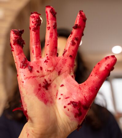 Red girl's hand in juice from beet.の写真素材