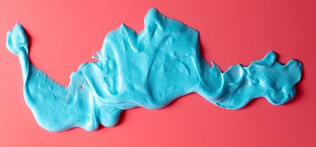 Blue slime isolated on pink background. Jelly-like material for children to playの写真素材