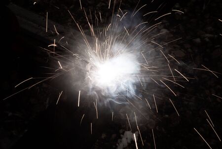 sparks from metal welding at a construction site.