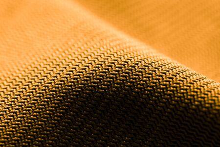 Golden fabric as an abstract background. Texture