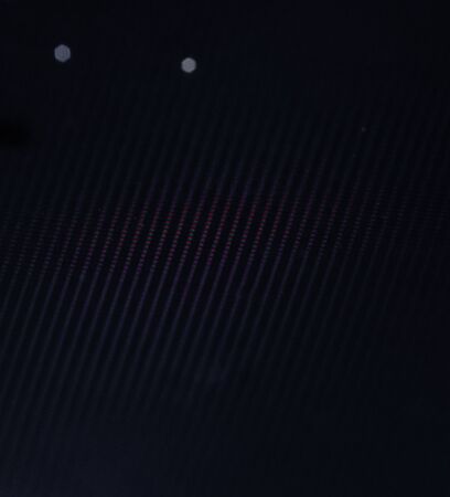 Glowing pixels on a black monitor screen. Macroの写真素材