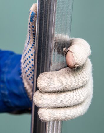 Worker cuts a metal profile for the walls. Repair of a room in the house.の写真素材