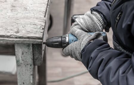 Worker fastens wooden planks. Repair of a room in the house.の写真素材